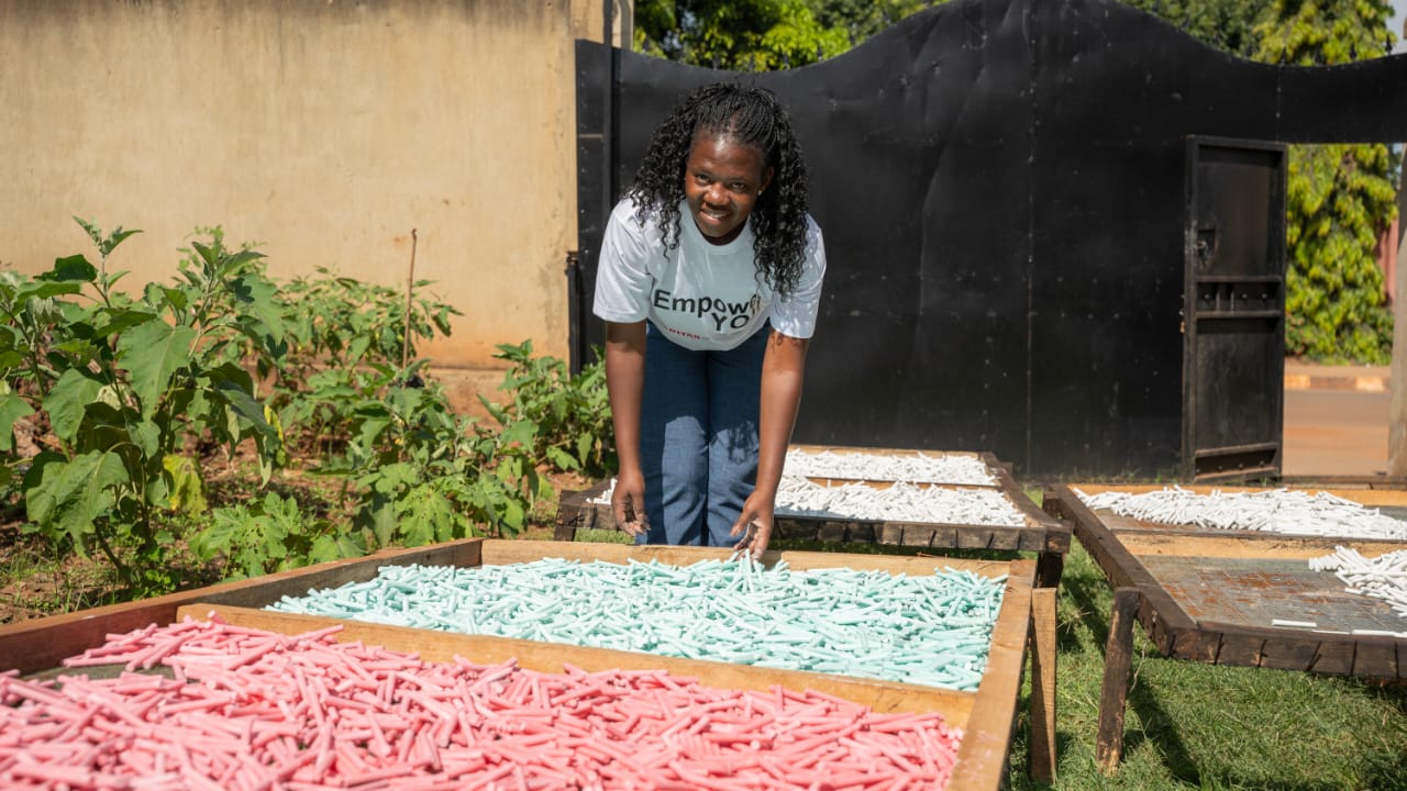 Ms.Caroline Aber sun drying chalk after production to support education system.